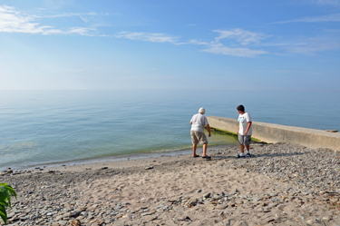 Lee Duquette and his grandson skip rocks into Lake Erie
