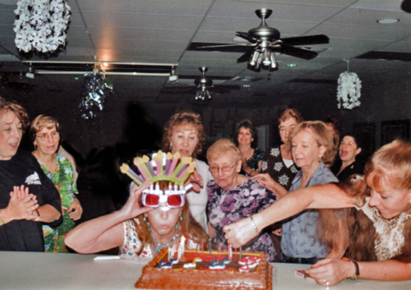 Karen Duquette blowing out the candles on her birthday cake