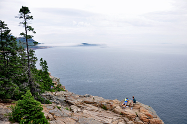 people on cliff at Acadia National Park