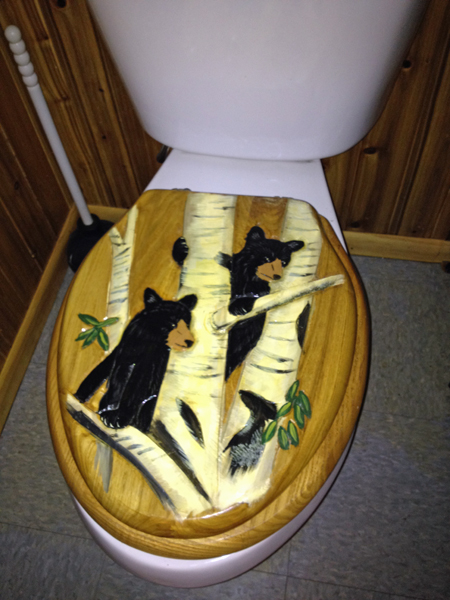 toilet seat cover in the restroom at Lemon Wolf Cafe