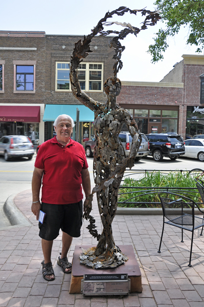 Lee Duquette with the Leaf Lady sculpture