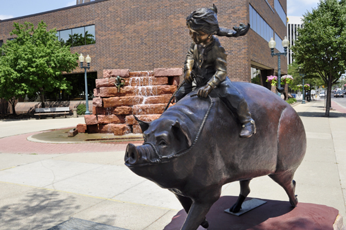 Girls Can Do Anything sculpture - girl riding a pig