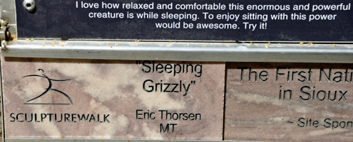 sign: Sleeping Grizzly sculpture