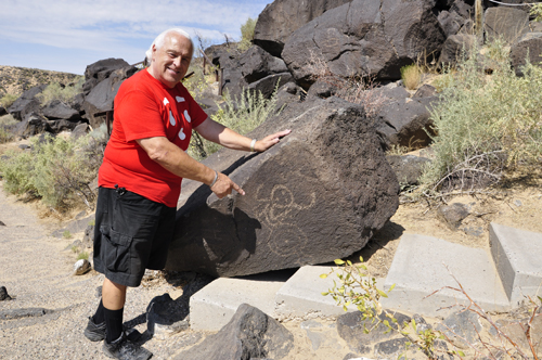 Lee Duquette and a petroglyphs on a rock atBoca Negra Canyon