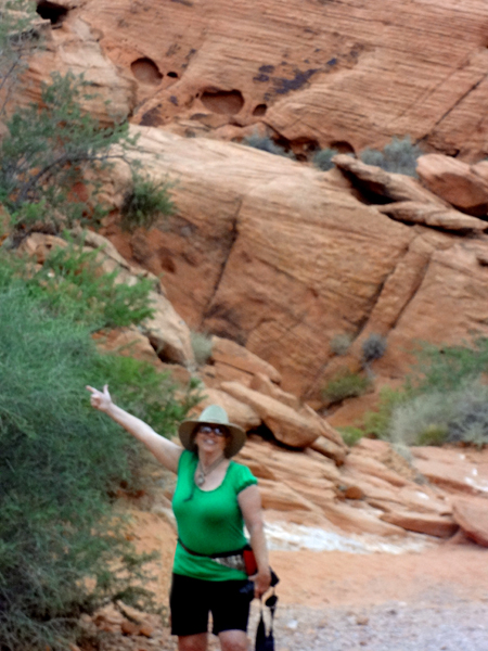 Karen Duquette by cliffs at Petroglyph Canyon trail