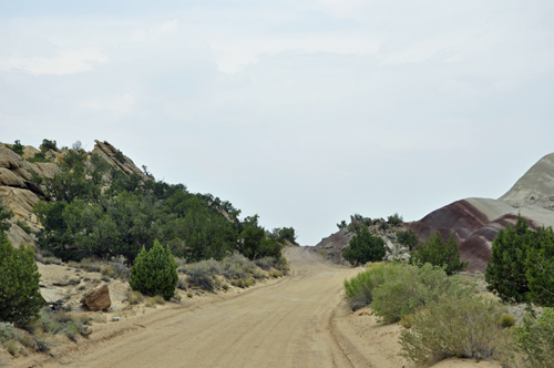 a hill with red dirt and white stripes.