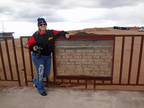 Karen Duquette at the Great Continental Divide sign