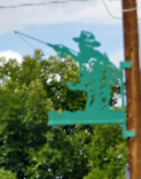green fisherman on light pole in Colorado