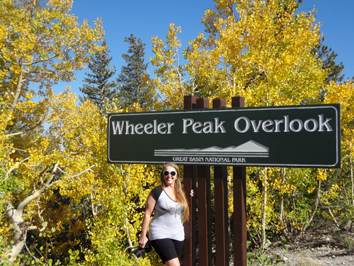 Karen Duquette at the Wheeler Peak Overlook sign