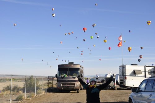 lots of hot air balloons over an RV