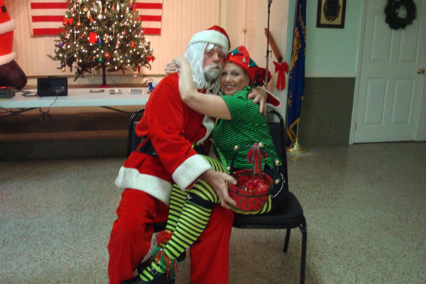 Santa Claus hugs the Christmas elf