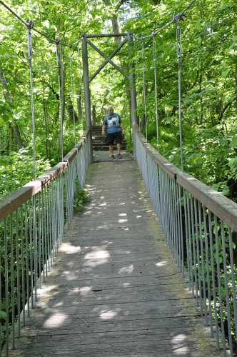Lee Duquette on a suspension bridge leading to Ramsey Falls