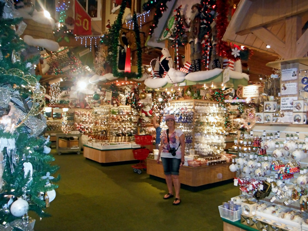 Karen Duquette and a small display of ornaments inside Bronners Christmas Wonderland