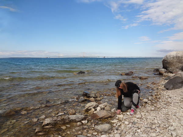 Karen Duquette feels the temperature of the water in Lake Michigan