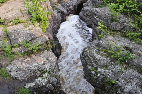 a rushing torrent as it is forced into the narrow river gorge.