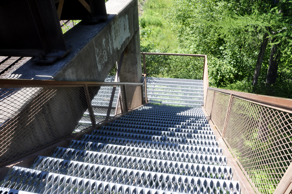 a staircase of 64 see-through metal grate steps.