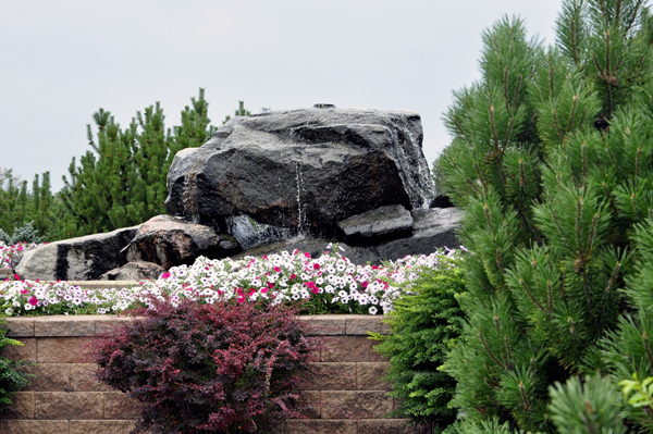a rock fountain and flowers near Capitol Lake