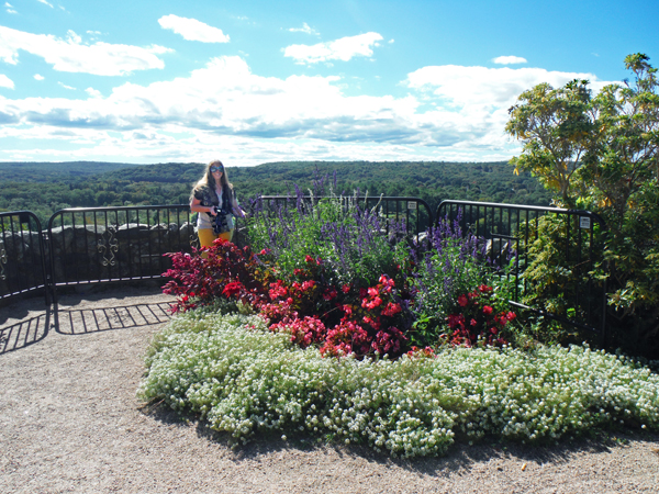 Karen Duquette and floweres behind Gillette's Castle