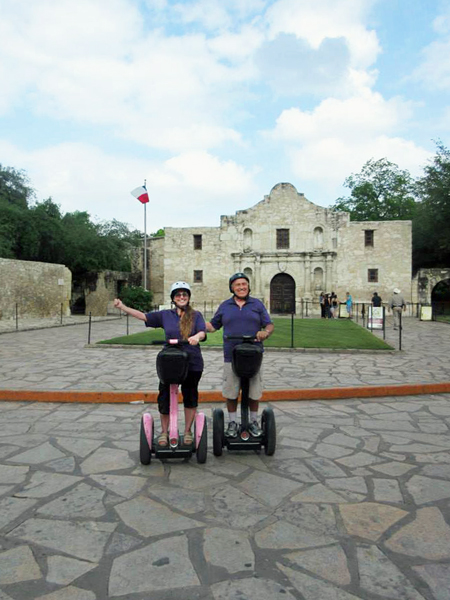 The two RV Gypsies in front of The Alamo on Segways