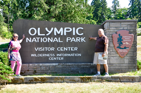Karen and Lee at the Olympic National Park Visitor Center sign