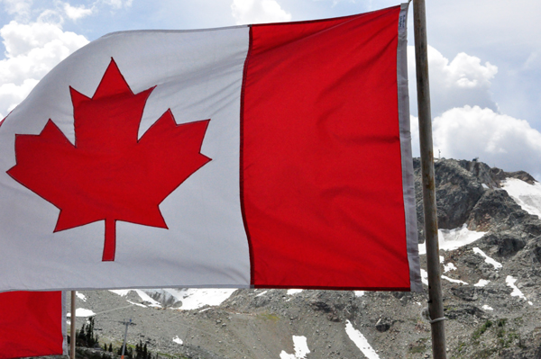 Canadian flag and mountain with snow