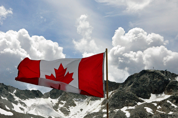 Canadian flag and mountain with snow