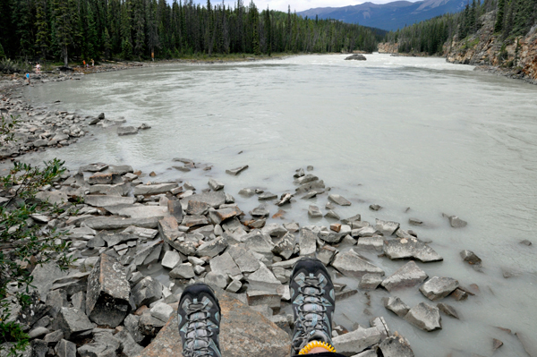 Karen's feet dangling over the Athabasca River
