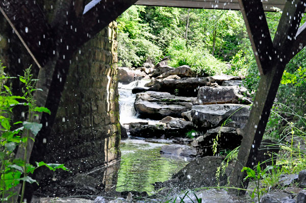 water flowing under the bridge