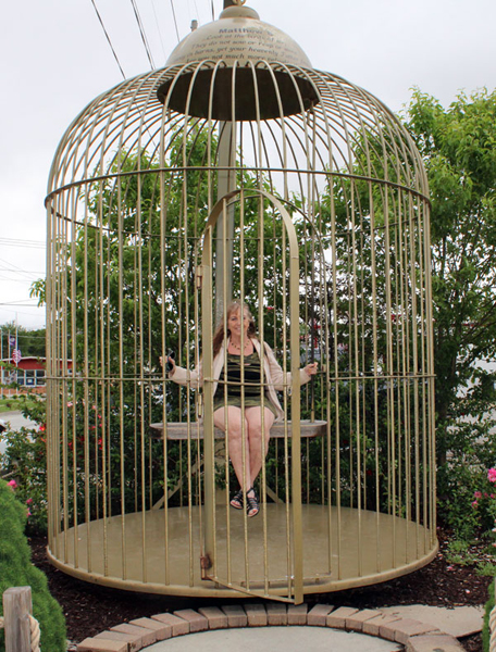 Karen Duquette in a bird cage