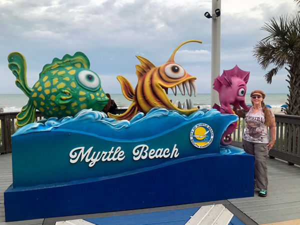 Karen Duquette at the Myrtle Beach fish sign