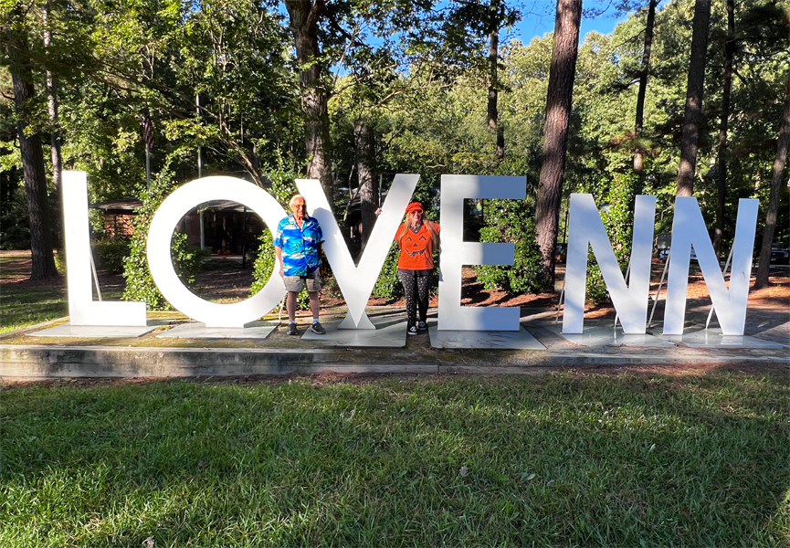 Lee and Karen Duquette at the Love NN sign