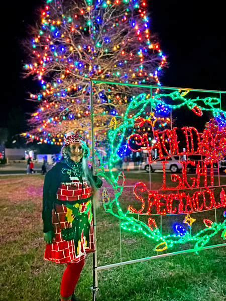 Karen Duquette at the Holiday Light Spectacular sign