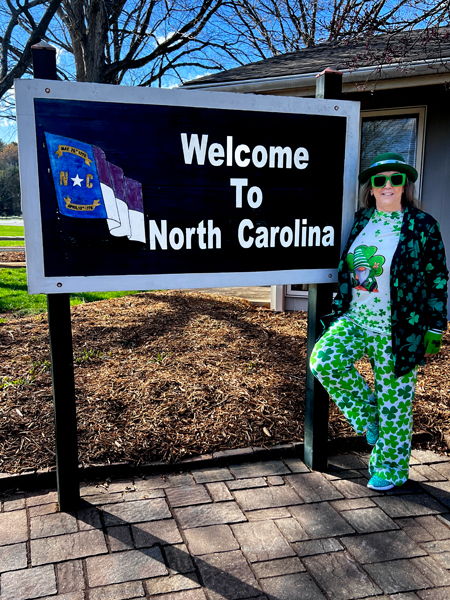 Karen Duquette at the Welcme to NC sign