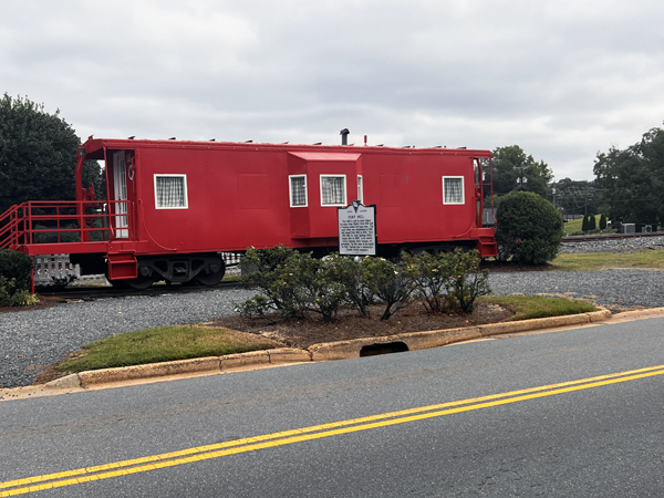 red train and a Fort Mill sign