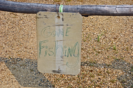 gone fishing sign on the post