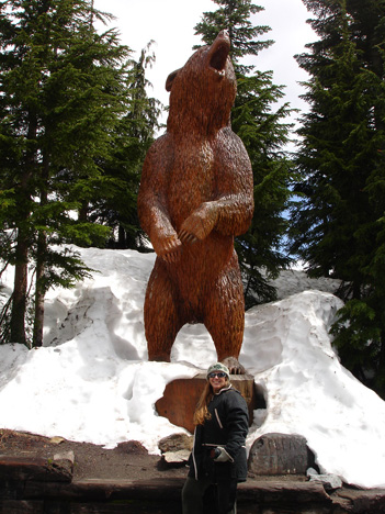 Karen Duquette and a bear carving