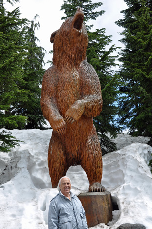 Lee Duquette and a bear carving