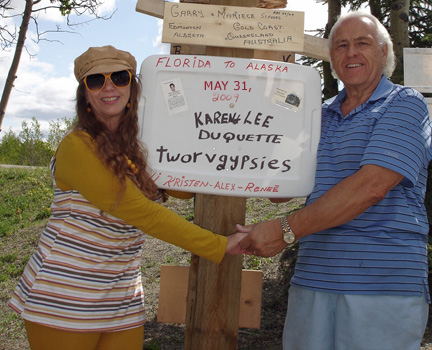 Lee and Karen Duquette with the sign for the two RV Gypsies