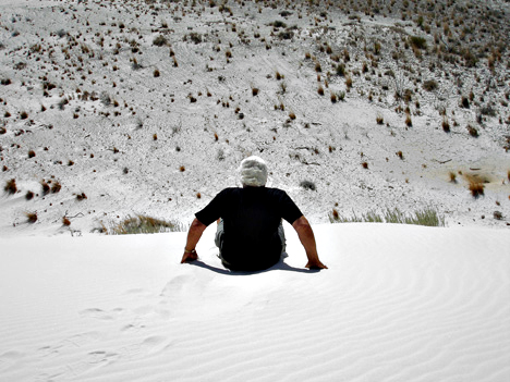 Lee Duquette sliding down the white sand dune