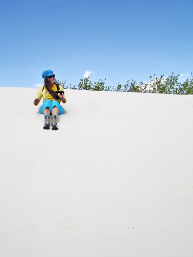 Karen sliding down the sand dune