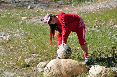 Karen checks out a small round rock
