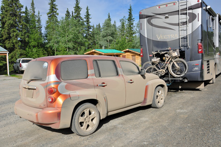 mud caked on the car and RV