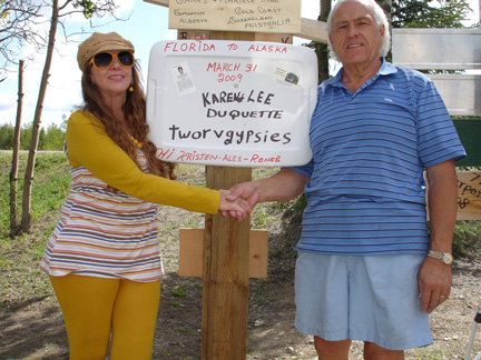 the two RV Gypsies with their sign