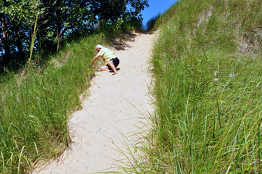 Lee gets up quickly to exit the hot sand dune