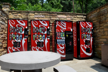 4 coca-cola machines in a row