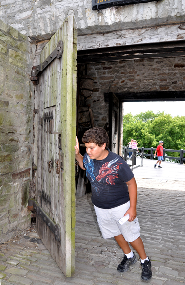 Alex opening the heavy door at Old Fort Niagara