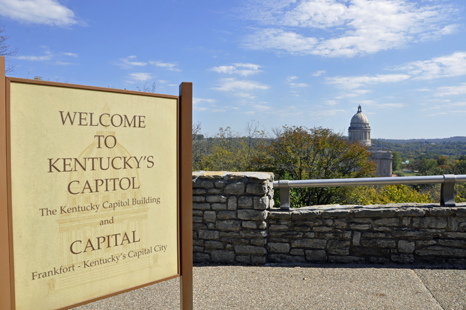 Kentucky's Capitol Building and a welcome sign