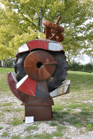 Tractor Town TitanKaren Duquette amist the Viva Sculpture