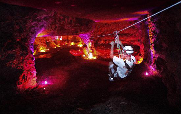 someone on the zip line in the Mega Cavern
