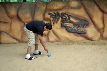 Alex acting as a paleontologist doing some field work in the Boneyard at Dinosaur World.